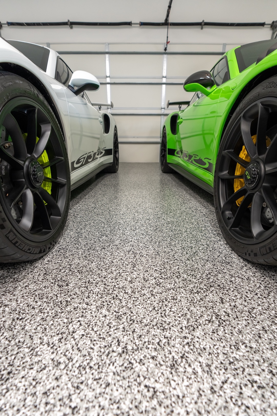 best concrete floor coating in garage with white and green cars parked